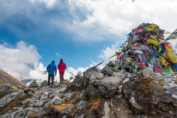 couple trekker standing and look at Thukla pass on everest base camp route - obrazy, fototapety, plakaty