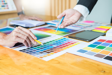 Creative Graphic designer at work. Color swatch samples pantone palette in studio modern office,...