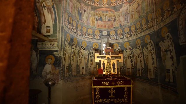 Revealing a golden church altar and a cross.
