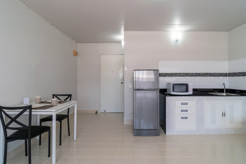 Luxury Interior bedroom with leather sofa of living room and kitchen in the same area, Studio room type of condominium or apartment, service apartment and Accommodations Concept