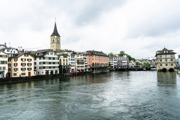 Fototapeta na wymiar A view of the buildings along the riverbank in Zurich