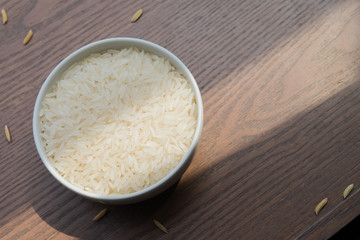 white rice on wood background with copy space, Organic rice and healthy food.