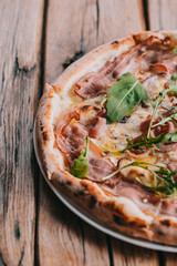 Pizza carbonara on rustic wooden table. Food photography concept. Top view