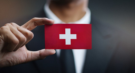 Businessman Holding Card of Switzerland Flag