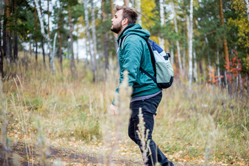 handsome male tourist hiking in the forest