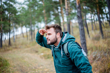 male hiker is looking at a distance
