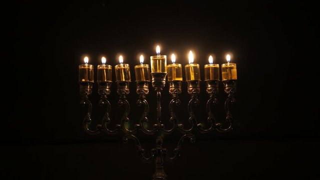 The 8th day of the Jewish holiday of Hanukkah. Beautiful Lit Hanukkah Menorah On Dark Background
