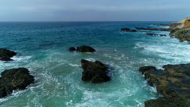 Ocean with rocks and homes