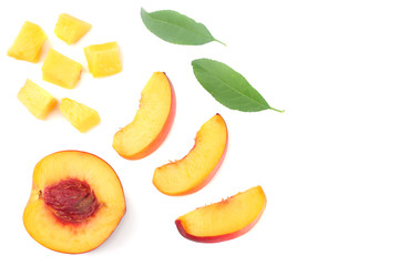 Nectarine with green leaf and slices isolated on white background. top view