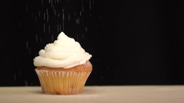 Pastry sprinkles on the cupcake icing sugar. Slow motion