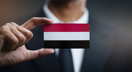 Businessman Holding Card of Yemen Flag