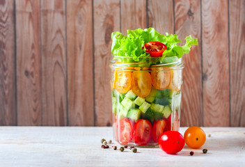 Fresh vegetable salad in a mason jar. Trends in healthy eating.