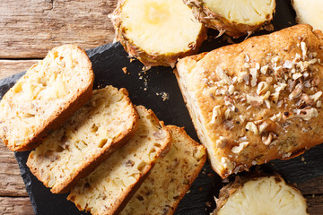 Fruit bread with pineapples, walnuts and raisins close-up. Horizontal top view