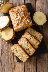 Freshly baked fruit bread muffins with fresh pineapples, walnuts and raisins close-up. Vertical top view