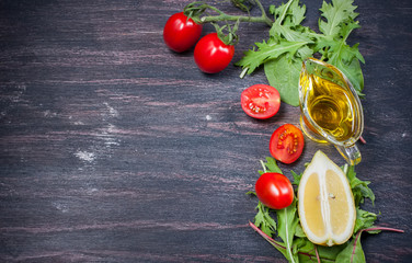 fresh cherry tomatoes, slices of lemon, lettuce and olive oil