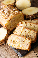 Freshly baked sliced pineapple bread with walnuts close-up. vertical