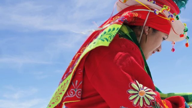 Traditional Bolivian dancing performed proudly by Indigenous South American female on Salar de Uyuni Salt flats wearing traditional costume 