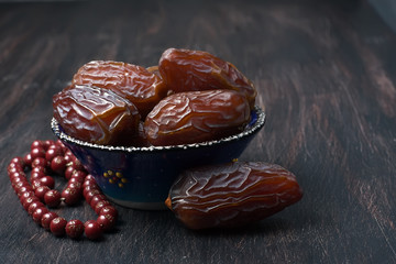 Dates fruit and rosary still life
