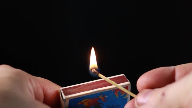 Lighting A Match From Matchbox And Blowing Out. Macro Close-Up