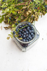 Fresh blueberries in a bowl, on a wooden table.