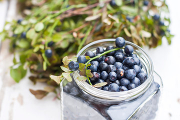 Fresh blueberries in a bowl, on a wooden table.
