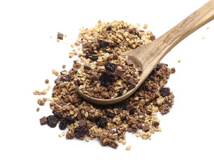 Crunchy granola, muesli with chocolate and cherry pieces and wooden spoon isolated on white...