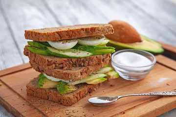 avocado sandwiches with egg and spices on a wooden Board