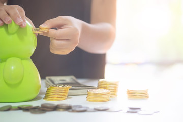 Saving money concept preset by Little girl hand stack coins to show saving money for future.