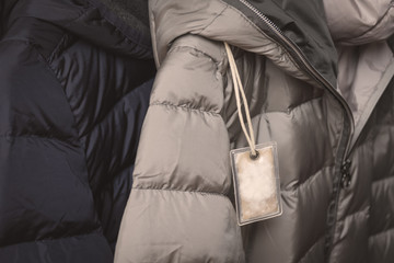 Small transparent plastic bag with winter jacket's filling (down) sample. Choosing qualitative filling for winter clothes.