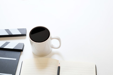 Office stuff with Movie clapper and coffee cup pencil notepad on table top view shot and copy space.