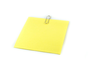 paper clip pin on white / yellow stick note paper with clip
