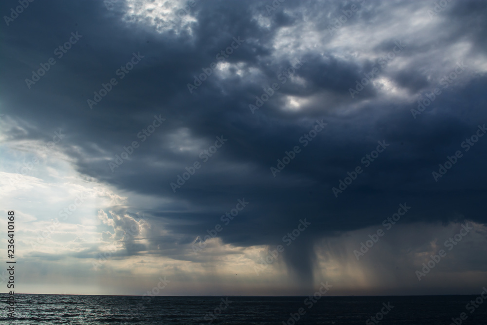 Wall mural storm clouds over the sea rain and thunder