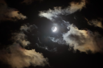 Fototapeta na wymiar Crescent in the dark cloudy sky