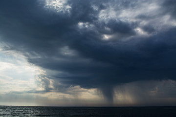 Fototapeta na wymiar Storm clouds over the sea rain and thunder