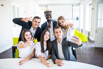 Fototapeta premium Successful business people with thumbs up and smiling. Business team in desk office.
