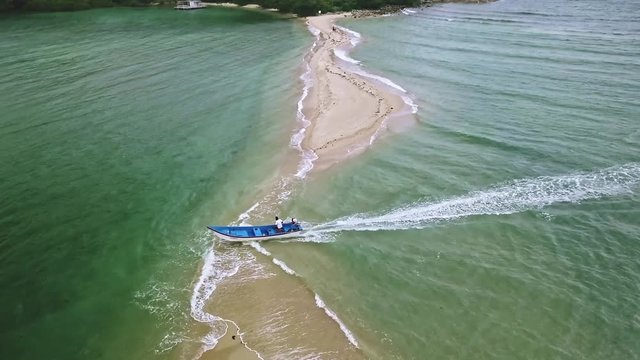 panoramic view from the air. fishing boat sails into the sea. the boat crosses the sandbank in southeast asia