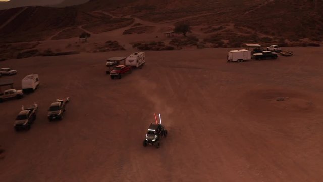 UTV riding back to camp at night with headlights on, Aerial Drone Footage
