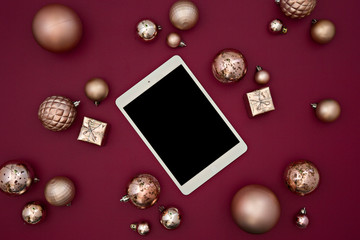 tablet with gold balls in red background