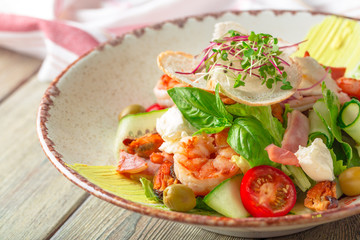 Fresh seafood salad served with prawns and greens