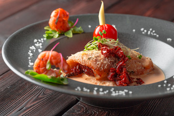Stuffed squid with parmesan cheese, onion and parsley in tomato sauce