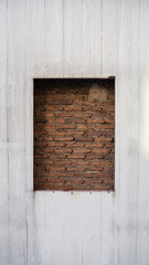 The beautiful sealed brick window in wooden wall for texture background with copy space, may use to interior design