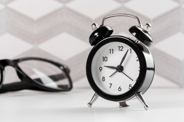 Vintage background with retro alarm clock on table