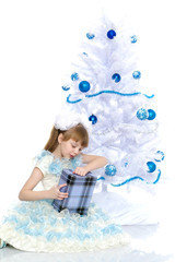 Fototapeta na wymiar The girl at the Christmas tree.