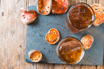 Bael juice ice tea on wooden table , healthy drink