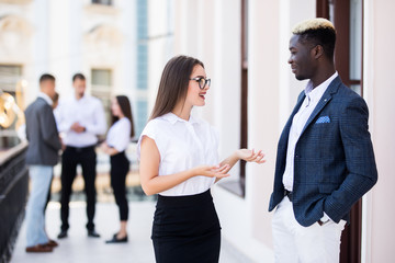 Coworking team meeting. Group of two businessmans working with new startup project in front of team in modern office.