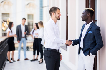 Handshake of business people at international business meeting in the office