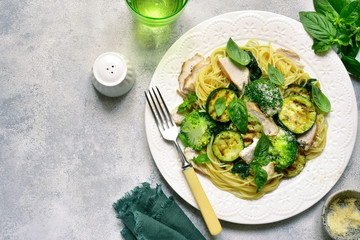 Pasta spaghetti with green vegetables and roasted chicken breast.Top view with copy space.