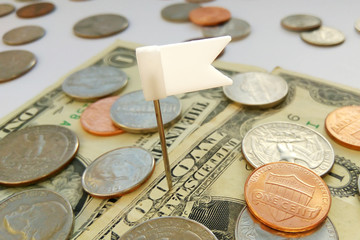 Close up American quarter, dime and penny coins on dollars usa background with pin flag. Concept of goal achievement, victory or defeat