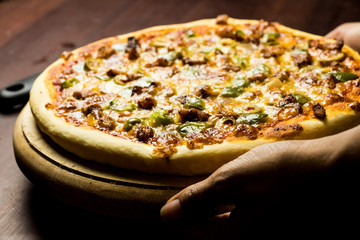 Pan Pizza take from side closeup hold hands