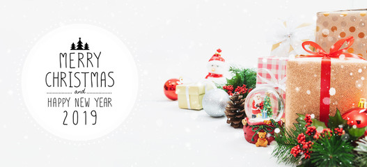 Christmas and New Year holidays gift box with decorative ornament on table with falling snow effect banner.Merry Christmas & Happy New Year 2019.Gifts and congratulations concept.